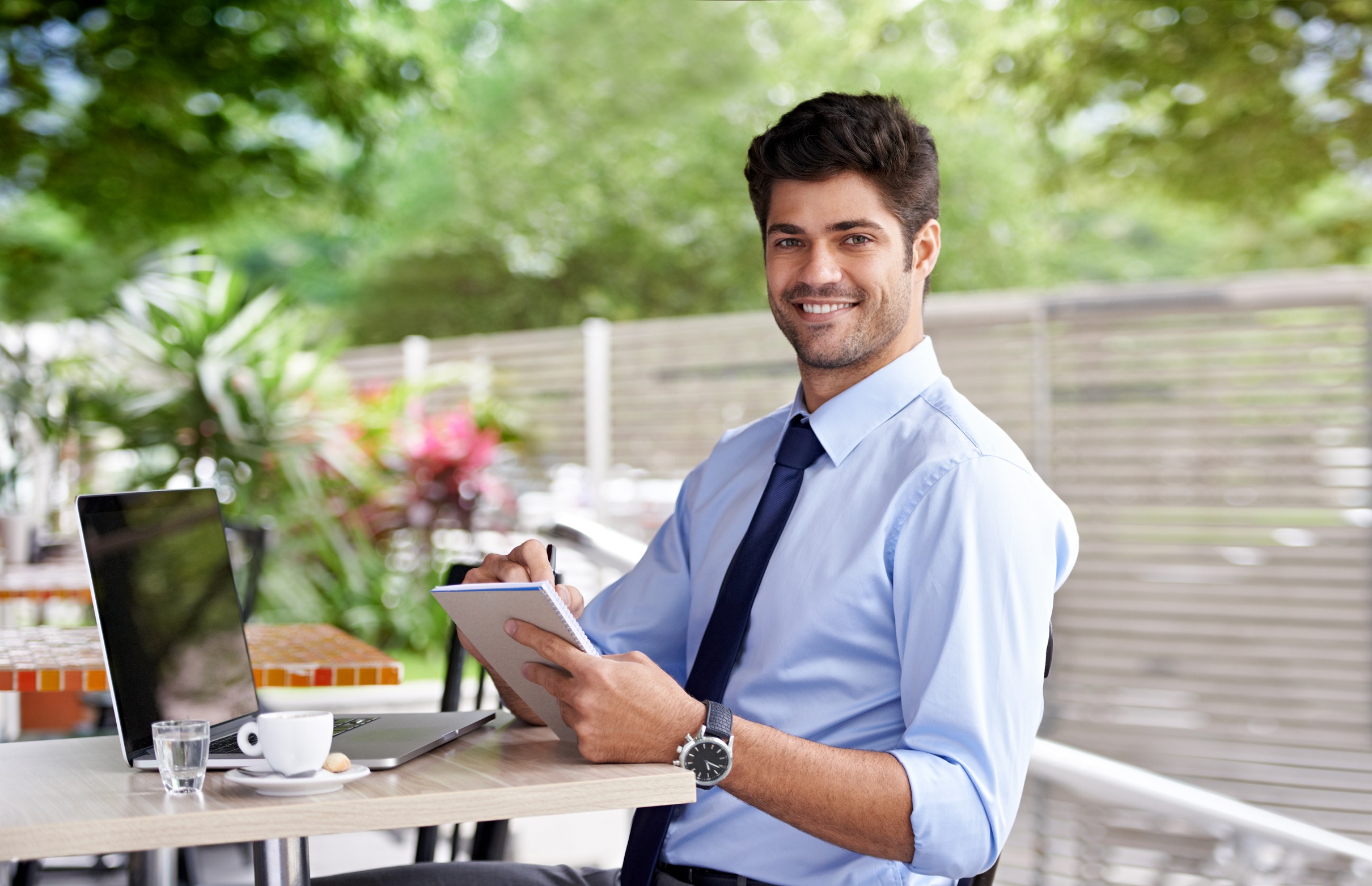A young adult absorbed in reading critical illness insurance material at a well-organized desk, indicating a thoughtful approach to health and career planning.